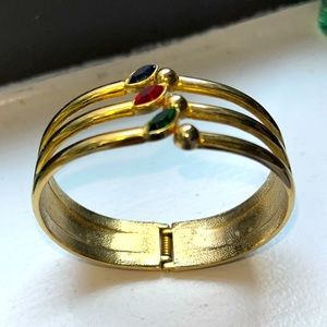 Vintage gold bangle bracelet, with three stones (red, blue and green)